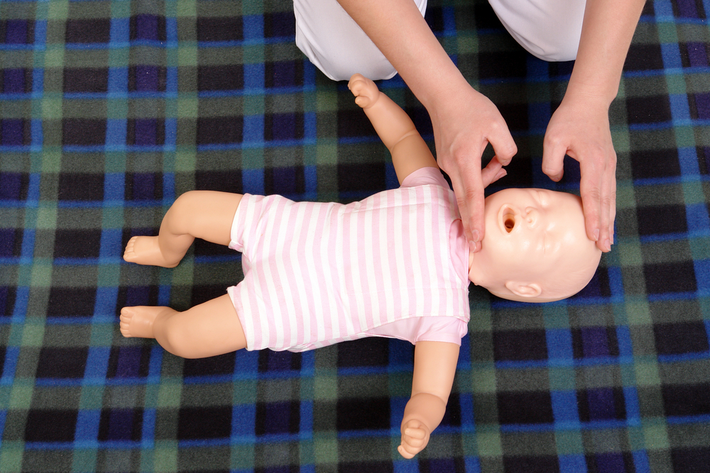 Teaching baby first aid skills using a training dummy with Riverside Cares